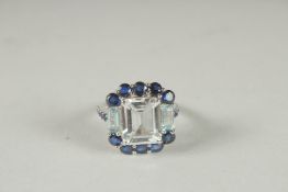 A LARGE SILVER WHITE TOPAZ, SAPPHIRE AND BLUE TOPAZ RING.