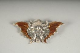 A SILVER AND ENAMEL DEVIL BROOCH.