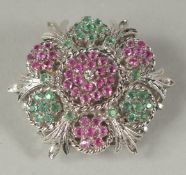 A GOOD 18CT WHITE GOLD DIAMOND RUBY AND EMERALD CIRCULAR BROOCH.