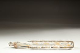 A LONG FACETED AND GILDED GLASS SCENT BOTTLE with gold stopper. 14cm long