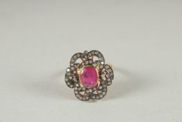 A GOLD AND SILVER RUBY AND DIAMOND RING.