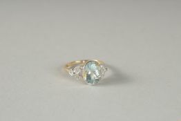 A GOOD 18CT GOLD OVAL AQUAMARINE AND DIAMOND RING.