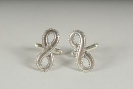 A PAIR OF INFINITY SILVER CUFF LINKS in a box.