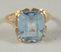 AN 18CT GOLD AQUAMARINE RING in a box.