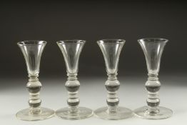 A SET OF FOUR PLAIN KNOP STEM WINE GLASSES. 7ins high.