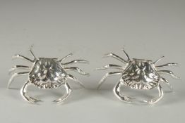 A PAIR OF SILVER PLATED CRAB TABLE SALTS. 4.5ins.