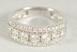 A GOOD 18CT WHITE GOLD THREE ROW DIAMOND HALF HOOP RING. Size N, in a box.
