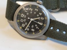 A US Military 1970s wrist watch, dated May 1971 verso and serial number 778811.