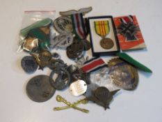 A quantity of assorted militaria inc badges and patches,