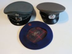 An East German Enlisted mans NVA Visor Cap, German Administration Visor Cap and a Soviet Beret.