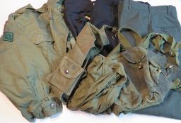 An AK assault vest, US Field Jacket, two schamags, US Army green trousers size 33s,