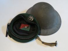 A WWII British Brodie helmet with liner and chin strap together with a French Foreign Legion
