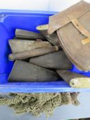 A quantity of wooden stocks with magazine pouch and helmet nettings.