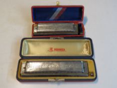 Two Harmonicas. One being 64 Chrominca by M.