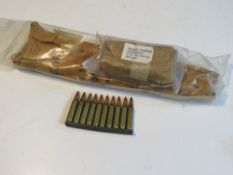 An M16 sling in packaging dated 1965, the bipod in packaging dated 1975 and ten 5.