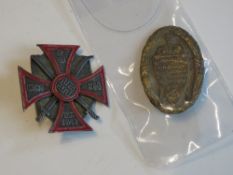 A WWII German 5th Don Cossack badge with Munchen 9 on the back and a SA Gruppe badge.