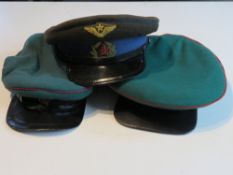 Two Soviet Border Force visor caps, together with a Soviet Officers visor cap. Three items.