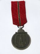 A WWII German Eastern Front medal, with original ribbon, (Officially known as,