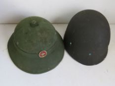 A Vietnamese Pith helmet and a US M1 liner.