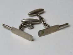 A pair of silver cufflinks having cricket bat design.