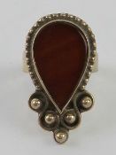 A handmade Indo-Asian design ring set with banded carnelian type stone, stamped 925, size P-Q.