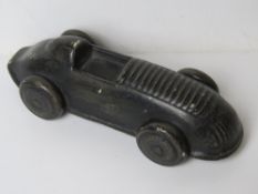 A ceramic paperweight in the form of a vintage racing car, approx 15.5cm in length.