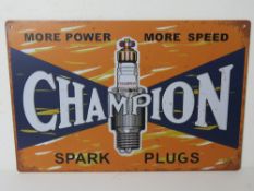 A contemporary metal garage Champion spark plug advertising sign 'More Power More Speed', 30 x 20cm.