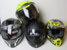 Four motorcycle helmets. For decorative use only, not tested for road use.
