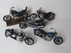 A set of five scale model vintage motorbikes inc Yamaha and Honda.