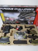 A Furious Challenger electric road racing set inc two cars, controllers and various track,