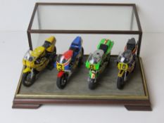 A set of four scale model racing bikes from the Big 4 Japanese manufacturers, Yamaha, Honda,