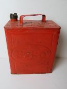 A red painted vintage Esso can with brass Esso cap, measuring approx 25cm wide.