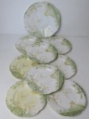 A cake plate with eight matching side plates marked England to base in cream and green floral
