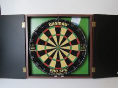 A dartboard within wall mounting case.