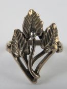 A silver ring having triple leaf design, stamped 925, size H.