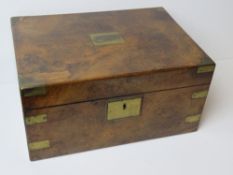 An antique writing slope having brass corner bracing, escutcheon and plate to lid,