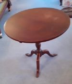 A late 19thC mahogany circular occasional table raised over short gun barrel stem terminating in