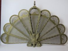 A 'peacock' fantail brass decorative fire-spit guard having nine panels, 96cm wide, 63cm high.