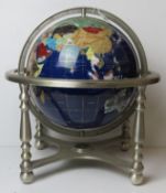 A semi-precious gemstone globe having compass to chromed metal base,