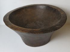 A large hand carved wooden Indo-Asian baking bowl approx 55cm dia.