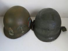 A US M1 helmet with liner and reproduction chin strap, liner dated 1971.