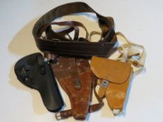 A US snub nose revolver shoulder holster and a Soviet PSM shoulder holster with a black holster and