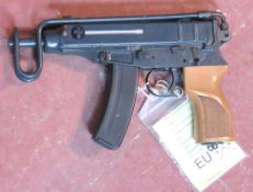 A deactivated Czech Skorpion Wz61 7.65mm sub machine gun with chequered wooden grip.