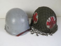 A WWII US M1 Medics helmet and a WWII Belgian Naval M1 helmet.