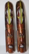 A large pair of contemporary Tiki style decorative wall carvings.