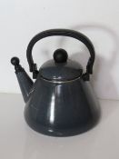 A Le Creuset teapot, slight enamel damage.