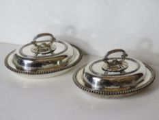 A pair of heavy silver plated lidded tureens.
