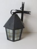 A wall light fitting in the form of a lantern.