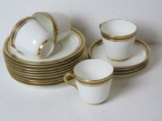 A white ground part tea set having gilded Greek key pattern border.