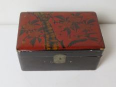 An Oriental style black and red lacquered box.